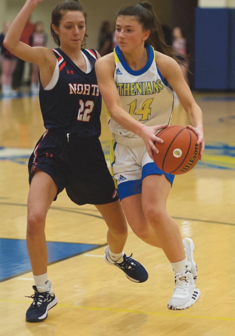 Crawfordsville's Shea Williamson drives past North Montgomery's Maddie Moseley. The Athenian sophomore is second on the team in scoring with 8 points per game.
