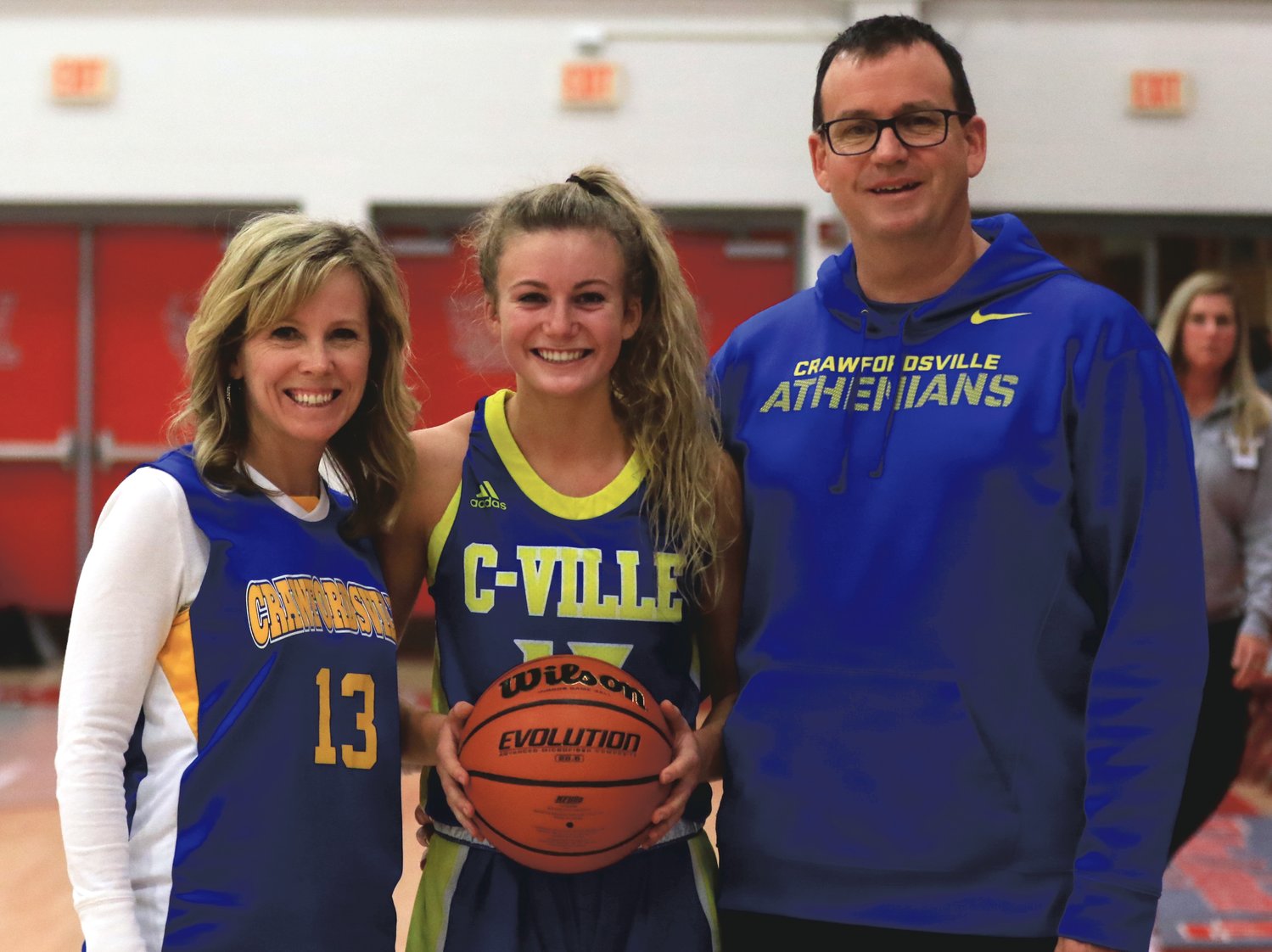 Crawfordsville senior Lauren Kellerman pose with her parents, Holly and Kevin, to celebrate her 1,000th point.