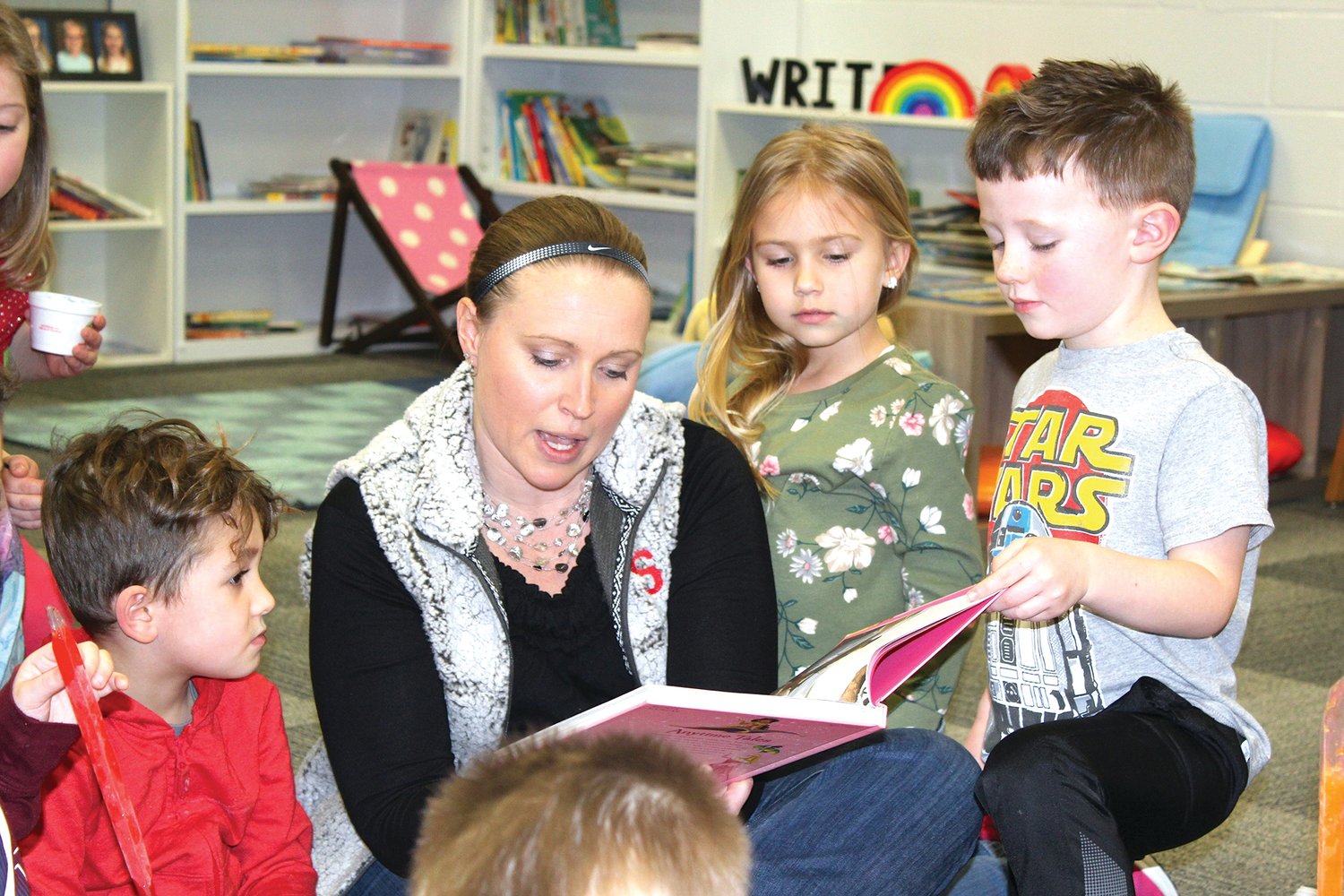 Little Mountie Preschool Instructor Kelly Shannon, center, reads a story to interested students Wednesday at Walnut Elementary.