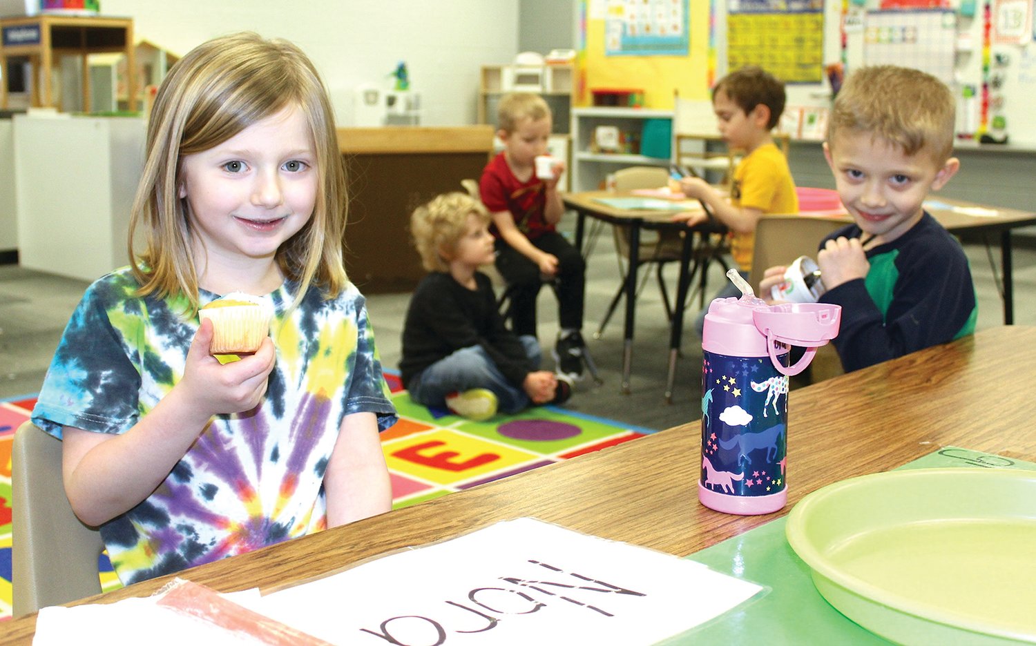 Little Mountie Preschool students Nora Stetler, left, and Levi Rhodes enjoy a snack before the end of the school day Wednesday at Walnut Elementary.