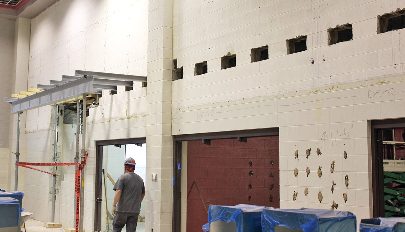 The northeast wall of the media center at Crawfordsville High School awaits partial demolition as new beams, called "needles" by the workers, are placed to support the upcoming raised ceiling.