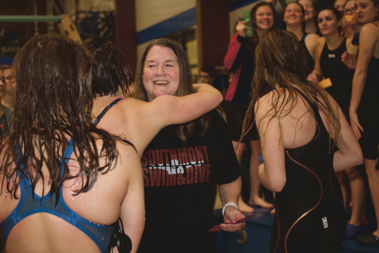 Southmont swimming and diving coach Jane Coudret gets a hug from her swimmers as the Mountie celebrate their sectional title.