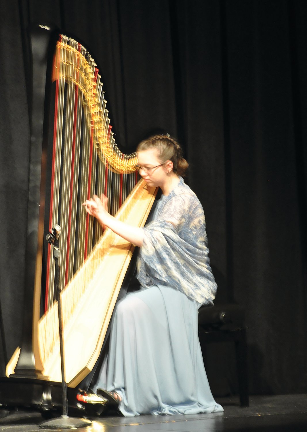 Third place winner Taylor Mermoud plays the harp Saturday in the MoCo's Got Talent for Scholarships competition at Crawfordsville High School. Students from across the county performed aerial and dance routines, music and a ventriloquist act to raise money for the alumni association.