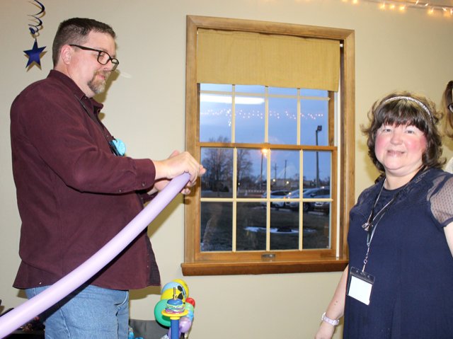 Alicia Cunningham, right, asks Nicholas Geigle for a balloon animal Friday during the Night to Shine event at New Hope Christian Church.