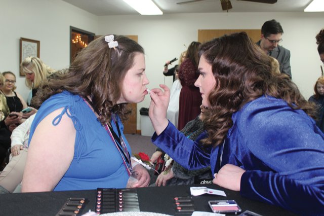 Edith Cline, left, has lipstick applied by Hair and Makeup station stylist Erin Harper on Friday at New Hope Christian.