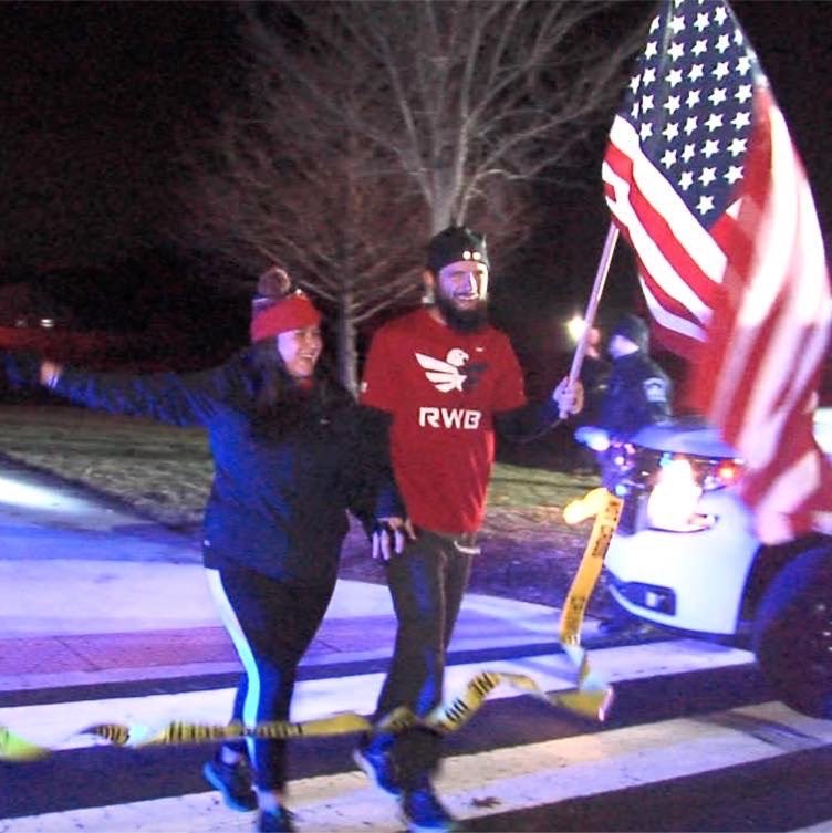 Dustin Johnson and his wife cross the finish in his quest to run 100 miles in 24 hours to raise awareness for veterans and veteran issues.