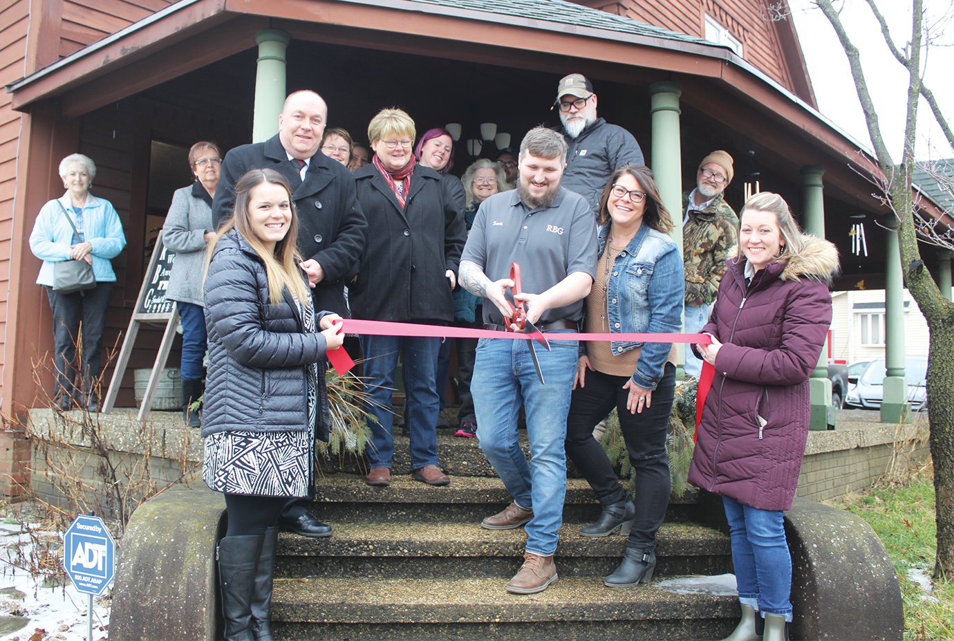 Chamber of Commerce Assistant Director Casey Hockersmith, from left, Mayor Todd Barton, Sue Lucas, Travis Harrington, Jami Harrington and Chamber of Commerce Executive Director Cassie Hagan cut the ribbon at Reclaimed by Grace's new location on Grant Avenue on Monday.