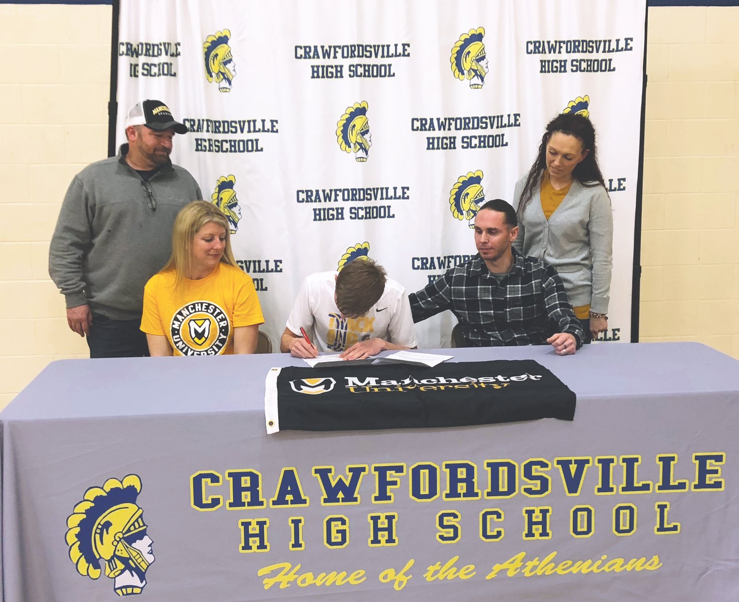 Crawfordsville senior Tristan Bronaugh has committed to continue his track and field career at Manchester University. PICTURED L-R: Tristan's Step-Dad, Mike Inskeep, Mom, Kathleen Inskeep, Tristan, Dad, Jason Bronaugh, and Step-Mom Jennifer Bronaugh