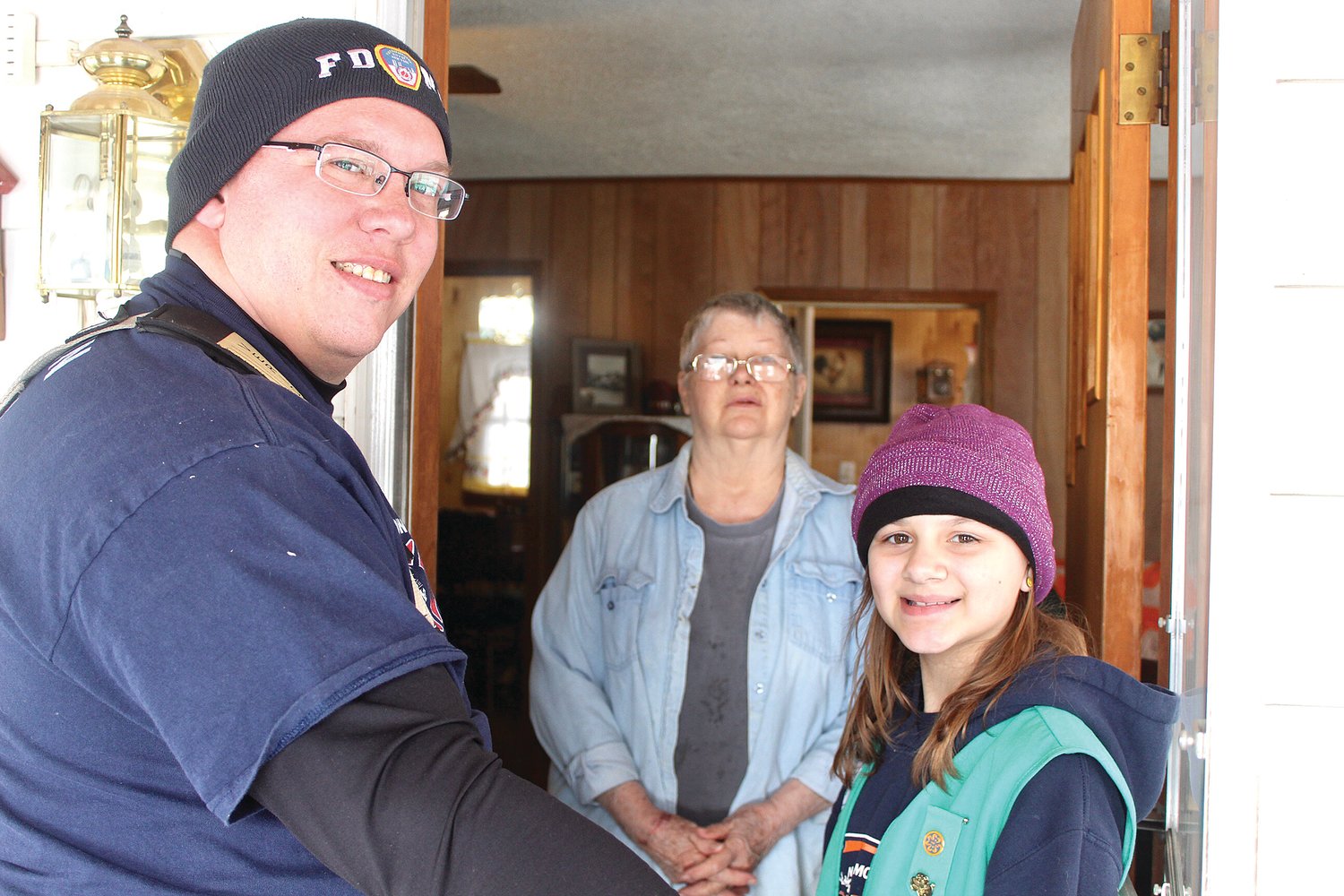 Waynetown resident Linda Wooten, center, receives a free box of Girl Scout cookies Saturday courtesy of the Waynetown Volunteer Fire Department, which purchased $500 of the annual treats for the elderly. Firefighter Ryan Clevinger, left, and Scout Elizabeth Ellingwood deliver the cookies personally.