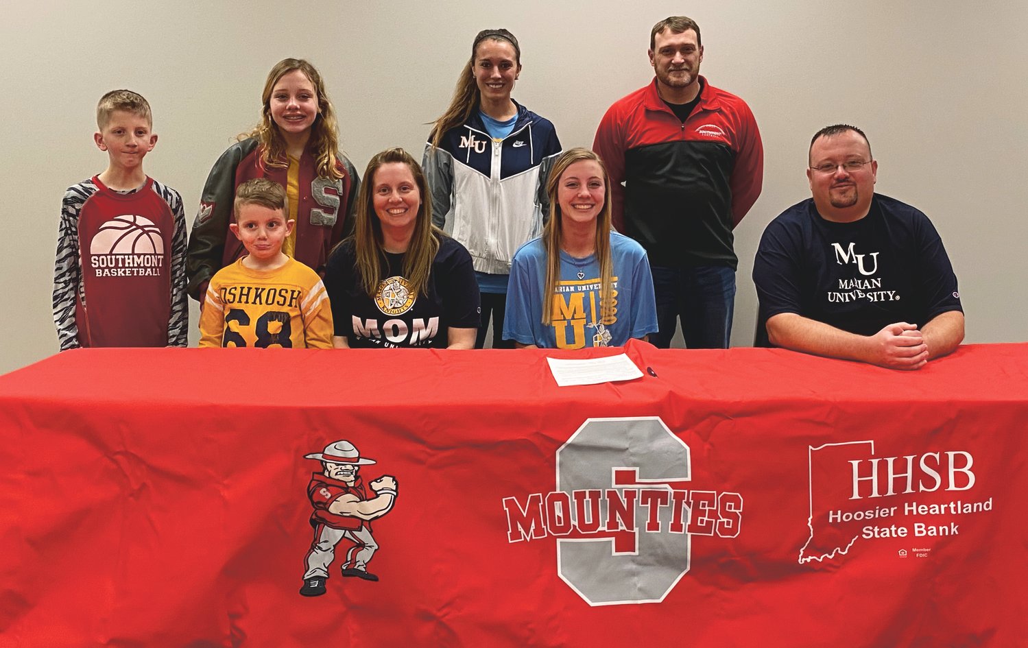 Southmont senior Lexie Odum committed to continue her track and field career at Marian University on Monday afternoon. PICTURED ABOVE: Lexie with her parents Dee and Philip Odum, brothers Finn and Gunner, and sister Lillie. Southmont track and field coach Desson Hannum, and Marian sprint coach Katie Wise.
