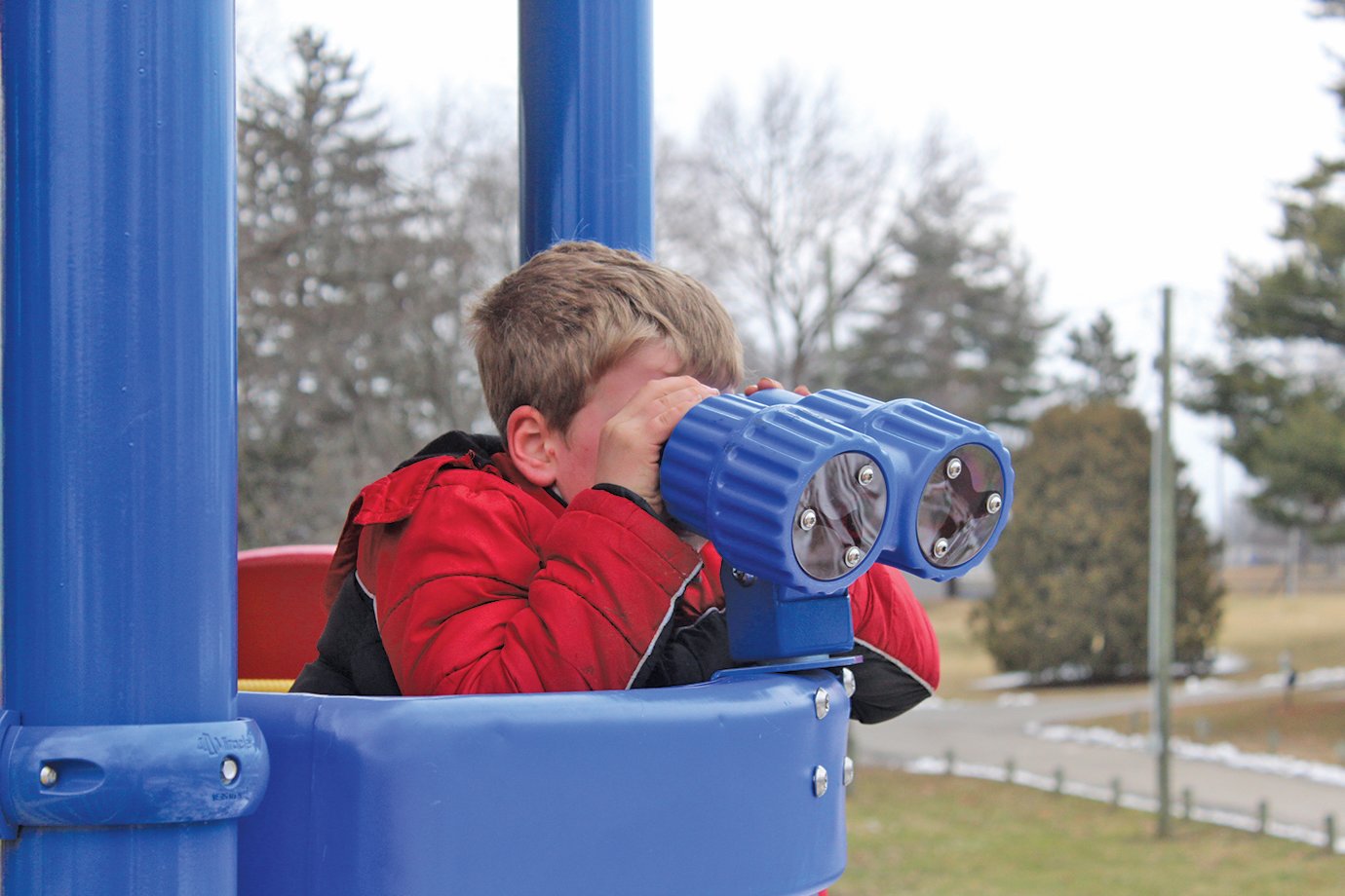 Clayton Ray, 7, observes Presidents Day from the eagles' nest of a playground at Milligan Park on Monday.