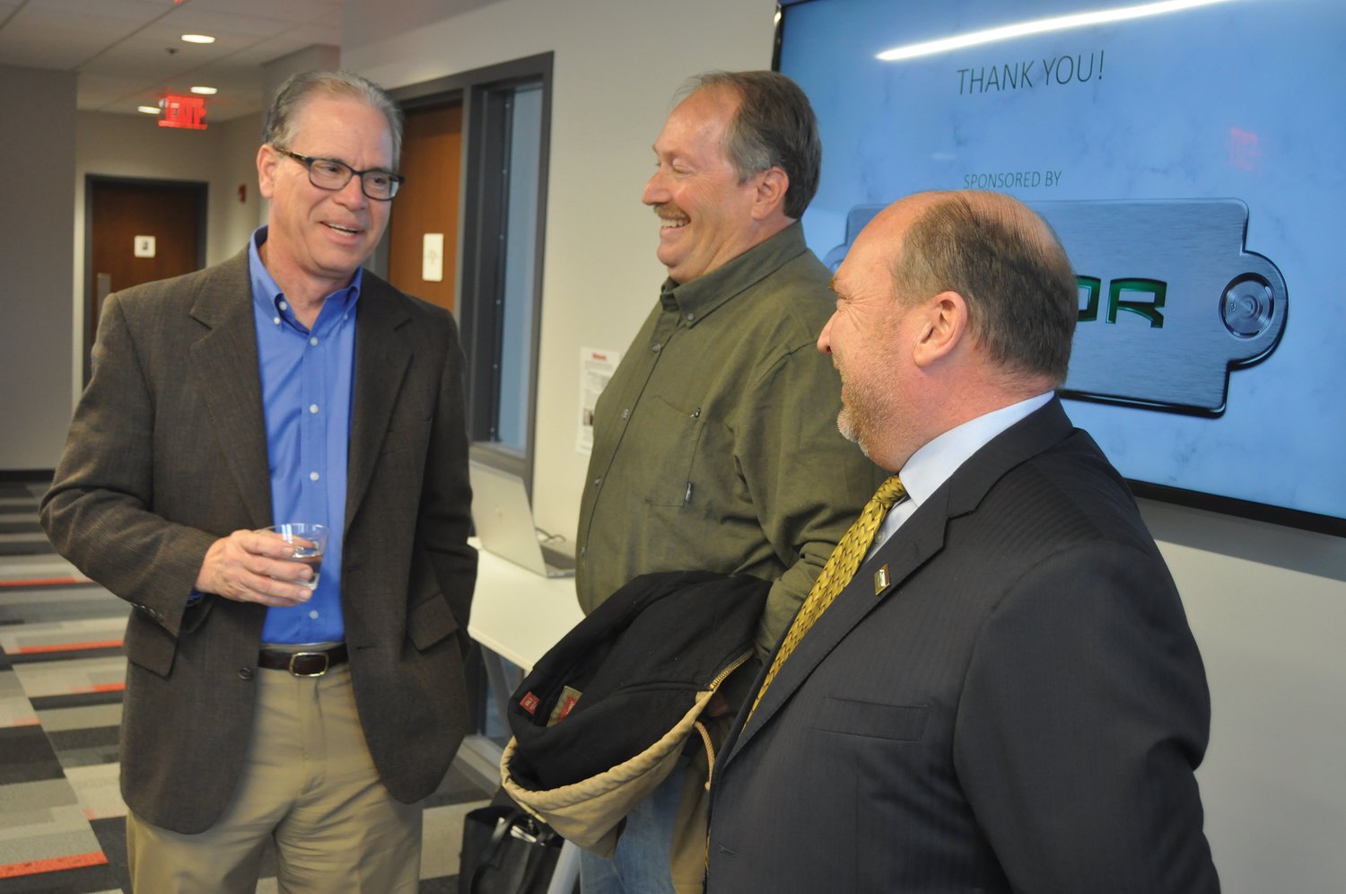 U.S. Sen. Mike Braun (R-Ind.) speaks with Gary Isenberg and Steve McLaughlin Tuesday during a meet-and-greet at Fusion 54.