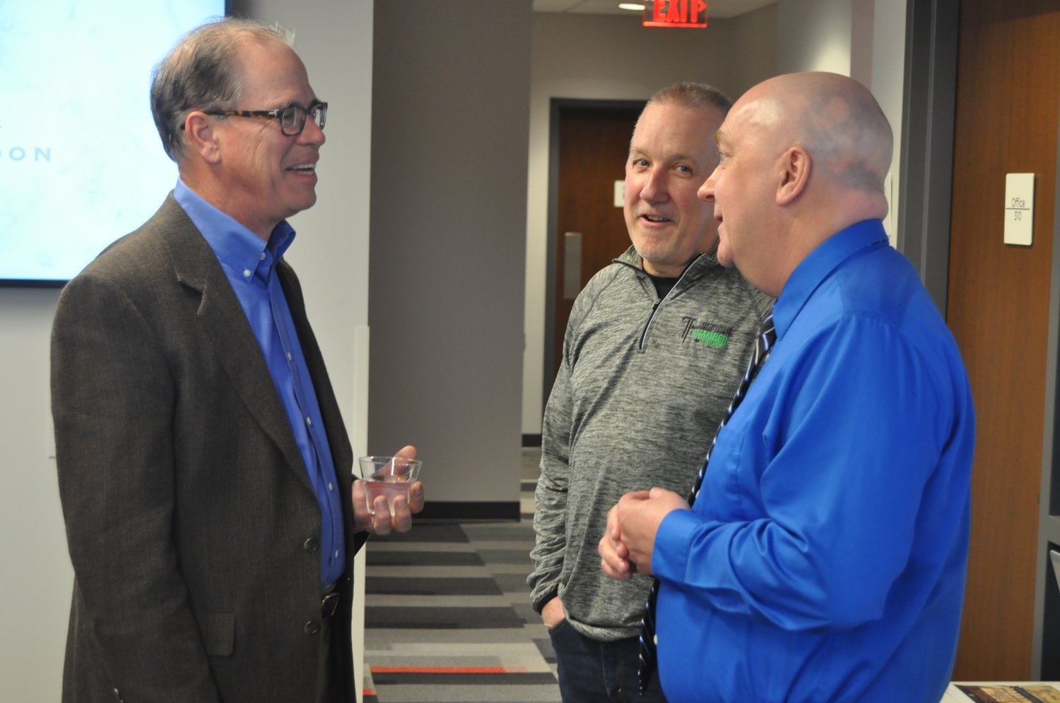 U.S. Sen. Mike Braun (R-Ind.) speaks with Crawfordville/Montgomery County Chamber of Commerce President Phil Littel and Crawfordsville Mayor Todd Barton Tuesday during a meet-and-greet at Fusion 54.