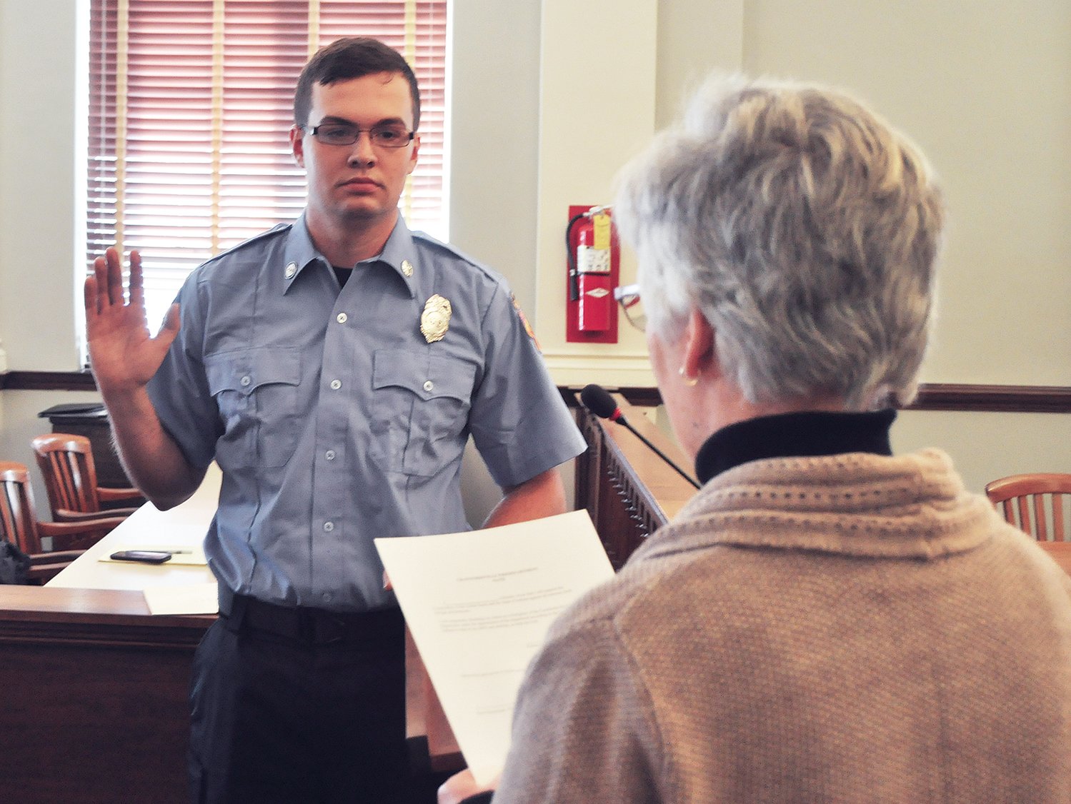 New Crawfordsville firefighter Kolten Cromwell is sworn in by clerk-treasurer Terri Gadd Wednesday at the City Building. Cromwell is the fifth member of the department to graduate from the West Central Career and Technical Education Cooperative's fire and rescue class.