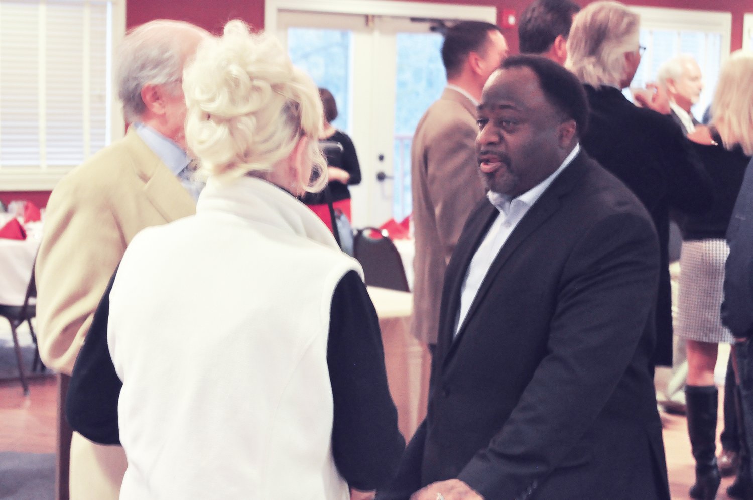 Political commentator Abdul Hakim-Shabazz chats with Kurt and Carol Homann on Tuesday before his remarks at the Montgomery County Lincoln Day Dinner at the Crawfordsville Country Club.