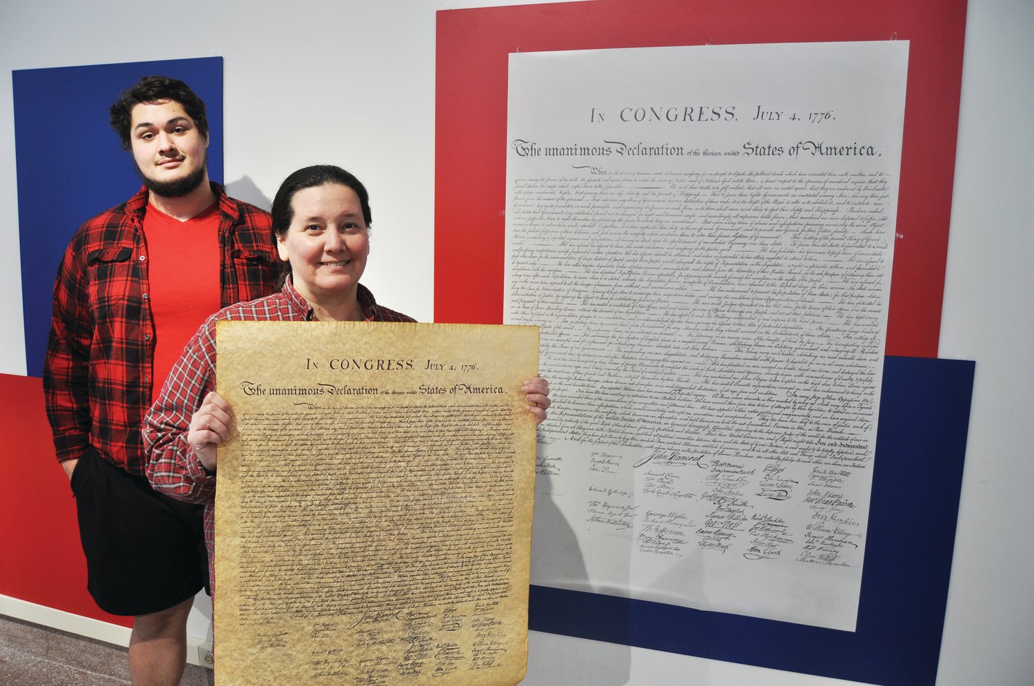 Carnegie Museum of Montgomery County director Kat Burkhart, standing with museum intern James Kirkland, holds a copy of the Declaration of Independence. The nation's founding documents are part of the museum's new exhibit "We the People, Me the Person," which opens Feb. 27.