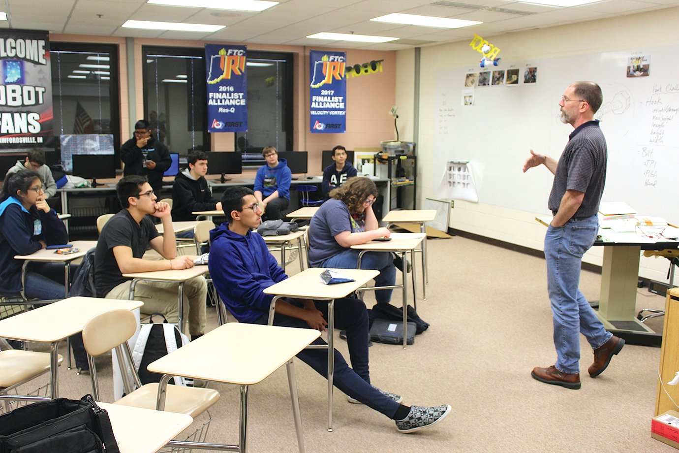 Engineering and computer science instructor Darrin Wilcoxson, right, begins a Crawfordsville High School Robotics Club meeting Tuesday. The meetings, which serve several purposes in both the classroom and laboratory, take place on Tuesdays and Thursdays each week after school.
