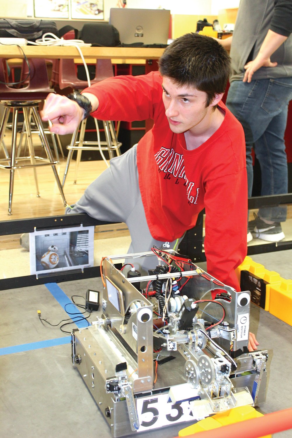 Lead programmer for the TOBOR robotics team at Crawfordsville High School, senior and fourth-year member Luka Mikek discusses how his team's robot operates. The devices utilize apps on ordinary smart phones as key links in the computing process.