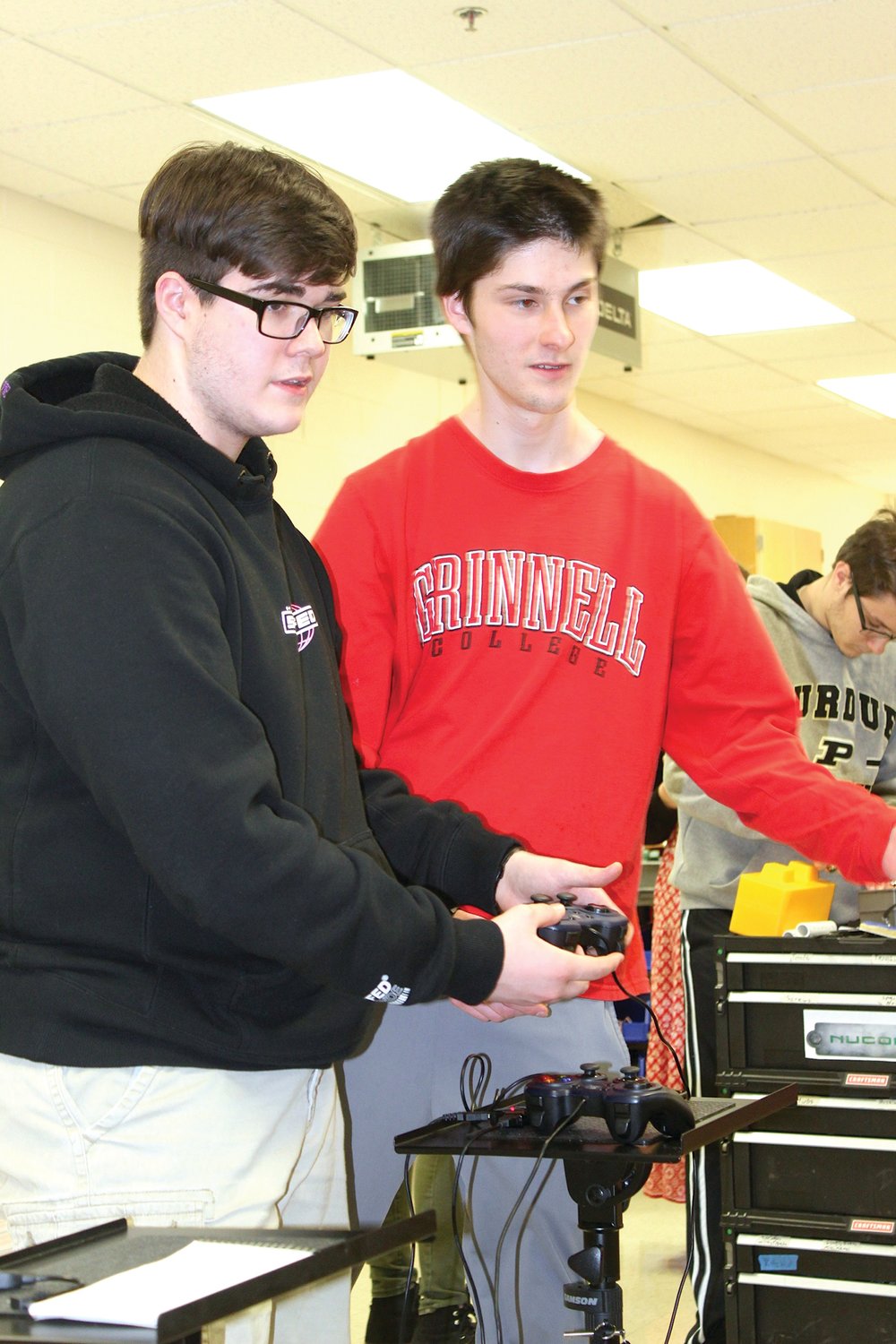 Main TOBOR team builder Ian Conright, left, and head programmer Luka Mikek discuss details of the operating process between themselves and their team's robot.
