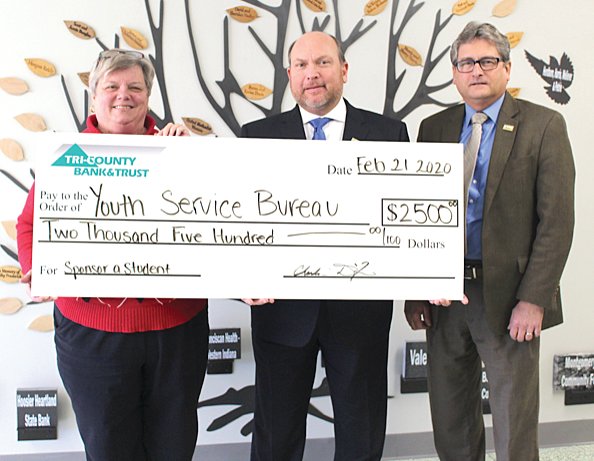 Montgomery County Youth Service Bureau Executive Director Karen Branch, left, receives a check made out to the bureau for $2,500 from Tri-County Bank & Trust Vice President Steven McLaughlin and Tri-County Bank & Trust President and CEO Chuck Dixon.