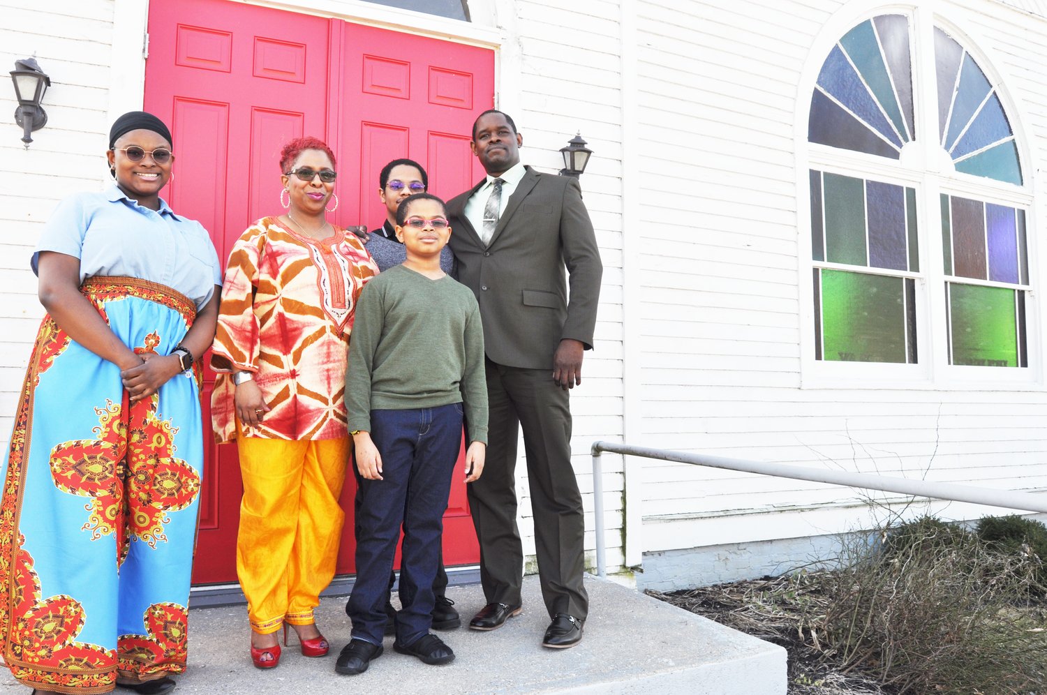 New Bethel AME pastor Rev. Joan Richardson, second from left, stands on the church steps with her children Emerald, Ryan and Alex, and husband Roger. Richardson began her duties at the church in January.