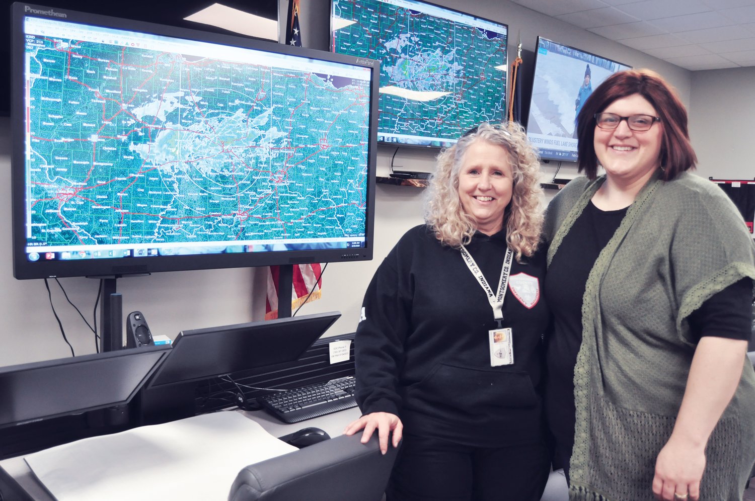 Reagan Knobloch, right, stands in the Montgomery County emergency command center with emergency management director Shari Harrington. Knobloch completed an internship with the emergency management agency this week.