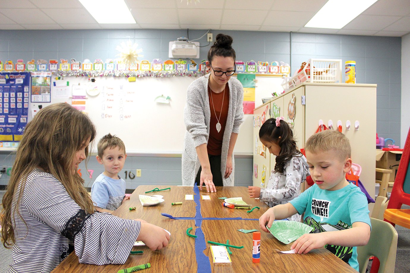 Faith Bales’ students at Little Mountie Preschool color and design dinosaurs and whatever else they can think of Thursday afternoon at New Market Elementary.