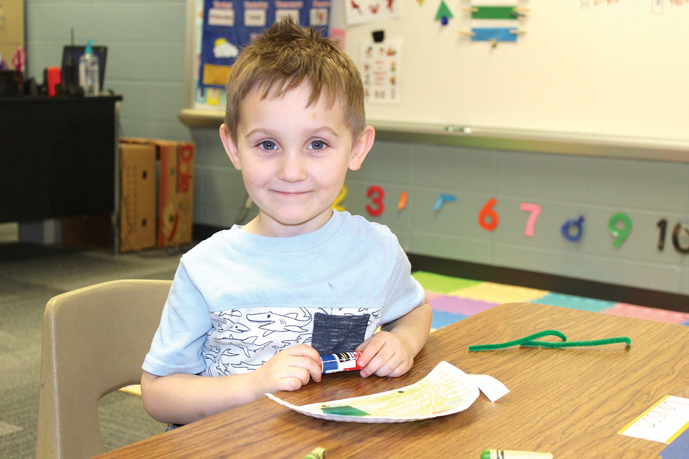 Preschool student Cayson Thomas takes a break from his dinosaur creation Thursday at New Market Elementary.