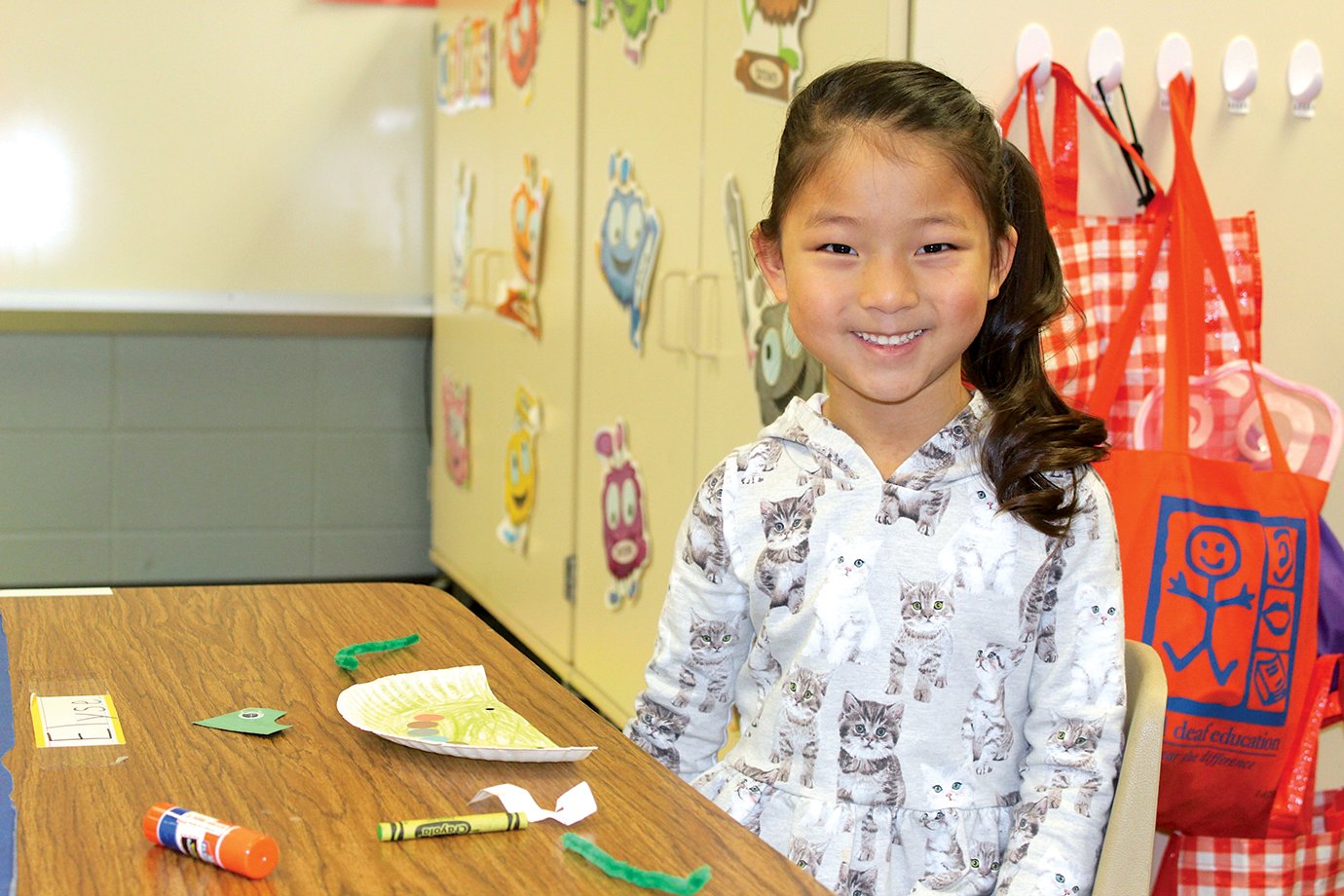 Preschooler Elyse Langevin is no stranger to creativity as she pauses her craft time for a photo Thursday.