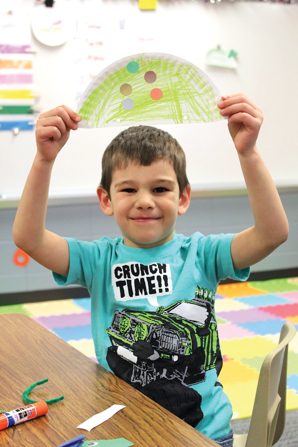 Little Mountie Preschool student Gage VanDorn holds his creation high Thursday to show everyone his artistic skills at New Market Elementary.