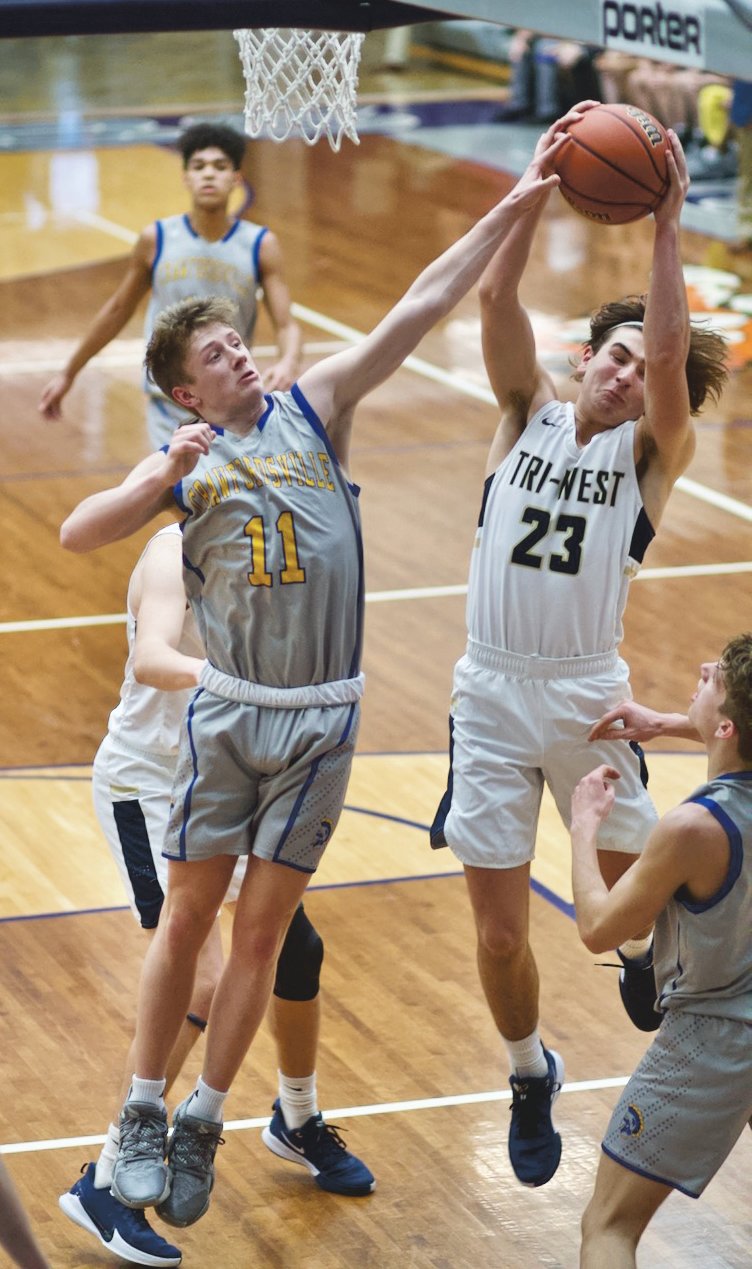 Crawfordsville's Karsten Williamson attempts to block the shot of Tri-West's Bryce Hendershot.