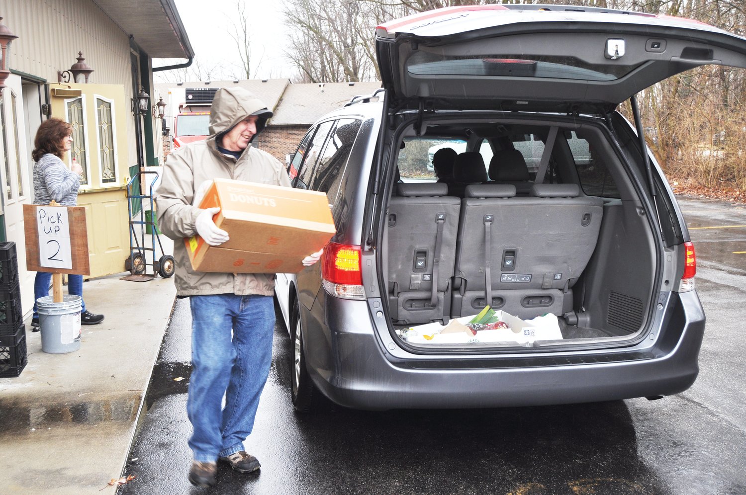 Dick Young carries a box of food to a vehicle Thursday at Grace & Mercy Ministries. Area food banks are expecting an uptick in clients due to the coronavirus (COVID-19) outbreak.