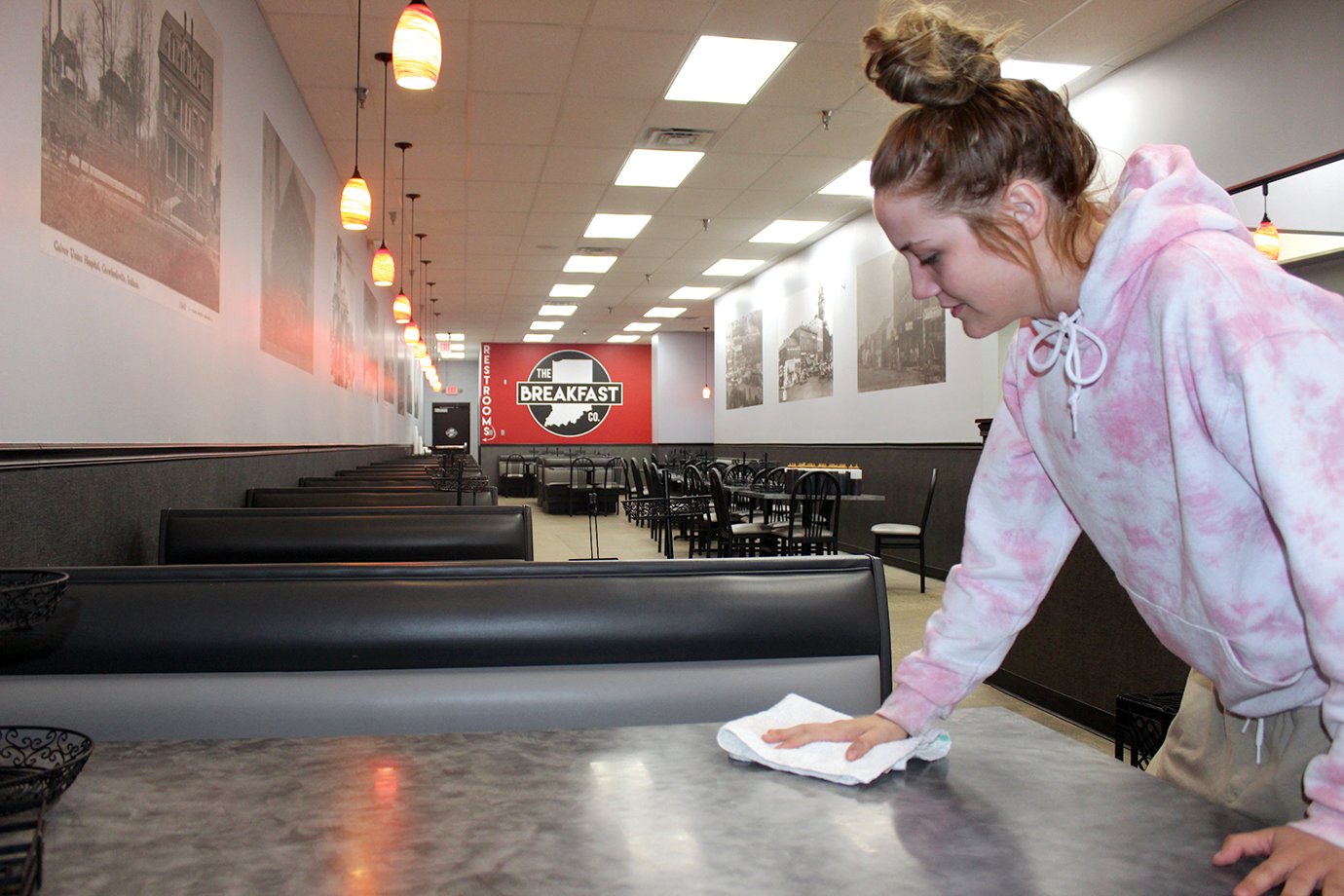 The Breakfast Company server Katie Price doubles down on sanitation Thursday inside the eerily empty restaurant, located in the Crawfordsville Square shopping plaza. Price and other servers whose paychecks rely heavily on tips have been weathering the storm of the coronavirus (COVID-19) crisis since the governor issued an order Monday that restaurants close dine-in services.