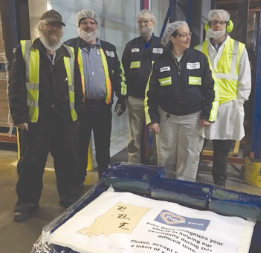 Pace Dairy associates Dennis Shultz, Rick Hunley, Kyle Posthauer, Cindy Wendall and Rob Garhart after pose for a photo after preparing cheese for shipment.
