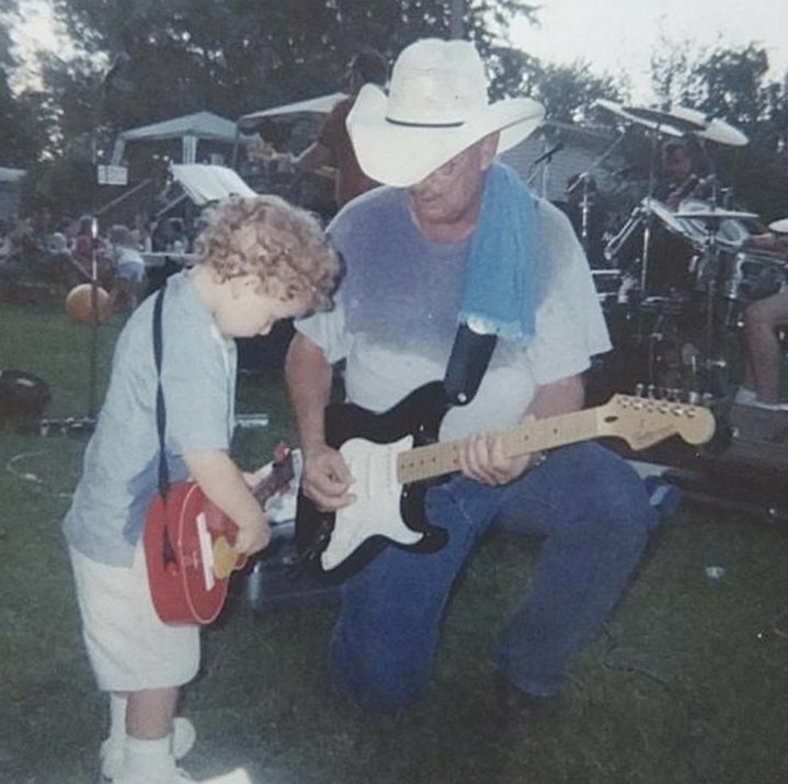 Jerry Rennick shares his guitar skills with a young musician.