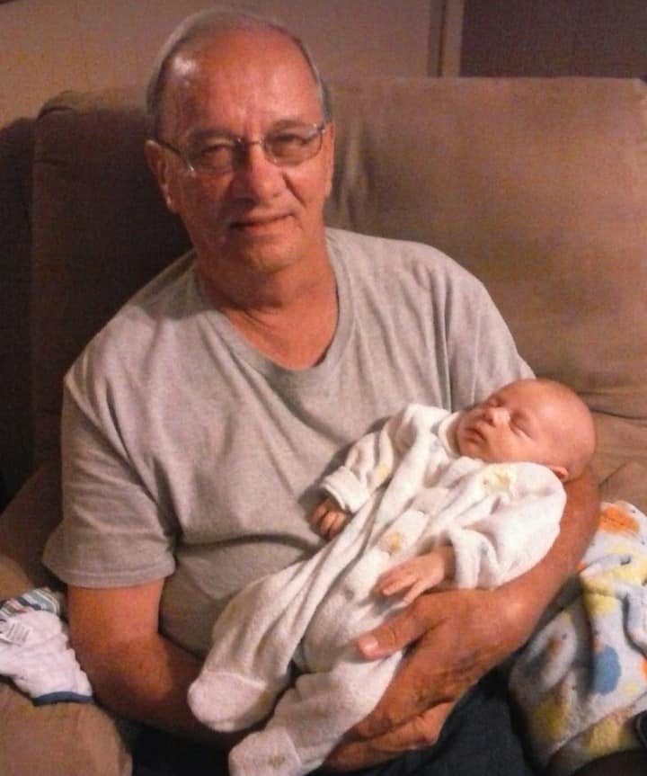 Jerry Rennick holds his youngest grandson, Camden, four years ago. Rennick is hospitalized in Indianapolis with COVID-19.
