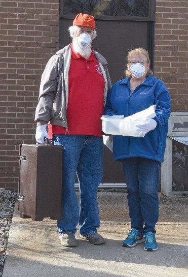 Volunteer drivers leave the hospital with meals.