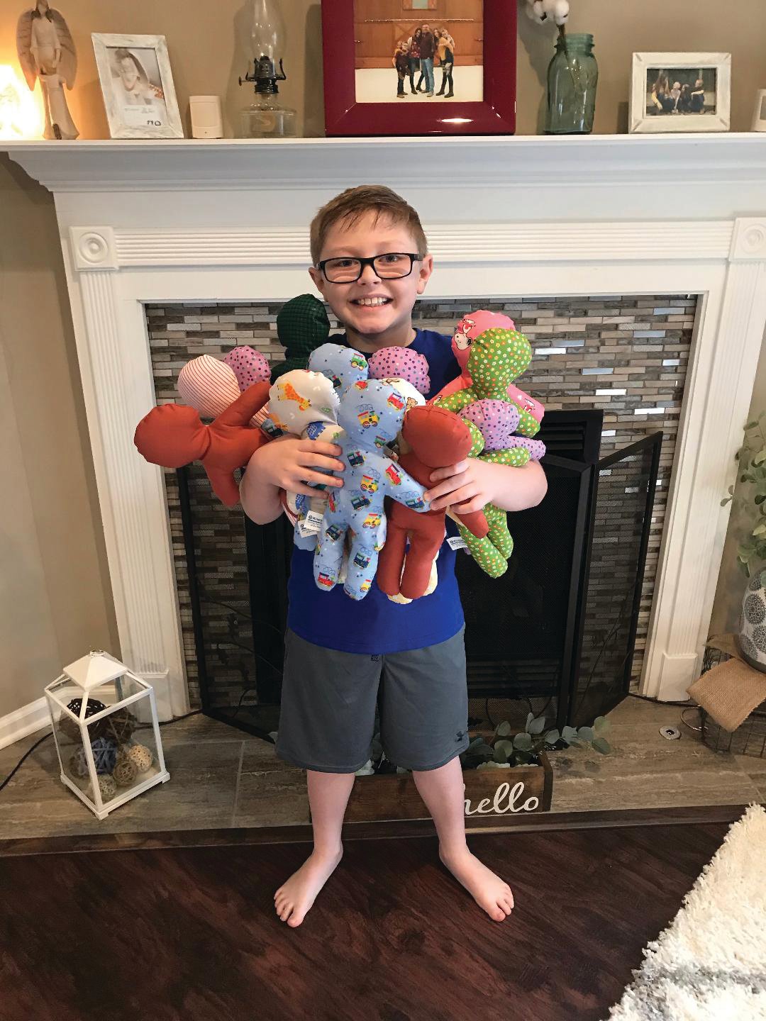 Alex Heisel, 9, holds the comfort dolls he made for the Crawfordsville Kiwanis Club. Twenty members, with help from their children and grandchildren, made the dolls for area advocacy groups.