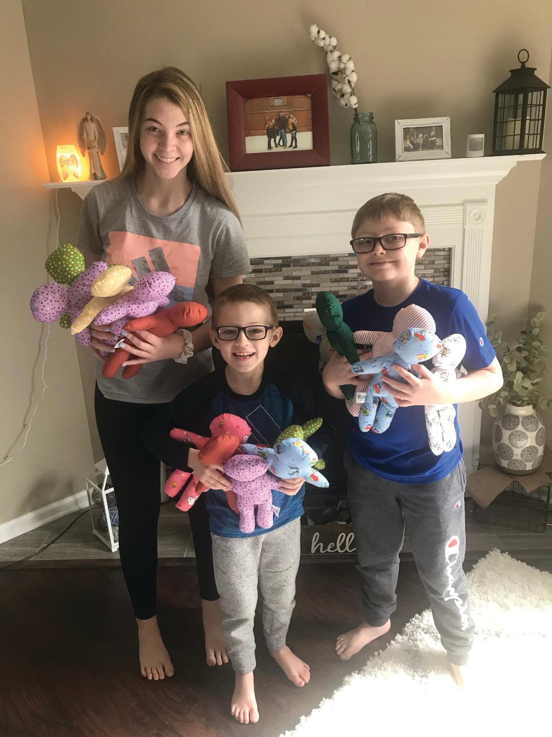 From left, Bella Mattingly, 15, Jackson Heisel, 6, and Alex Heisel, 9, show the comfort dolls they made for the Crawfordsville Kiwanis Club. The dolls will be distributed to the Family Crisis Shelter, Department of Child Services, Sylvia’s Child Advocacy Center of Lebanon and other agencies.