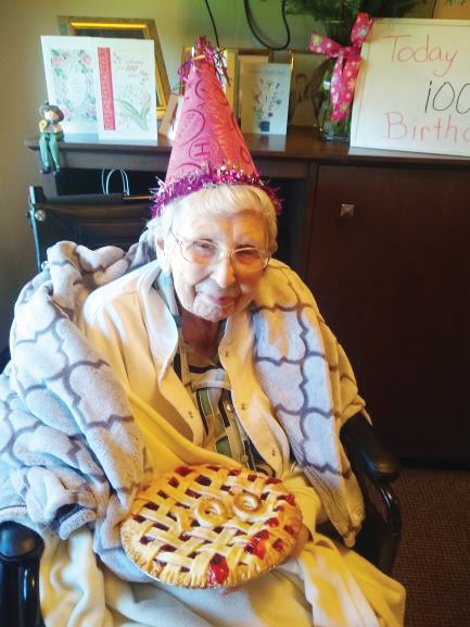 Jessie Grimes holds a cherry pie baked and delivered by Maxine's on Green to celebrate her 100th birthday at Wellbrooke of Crawfordsville.