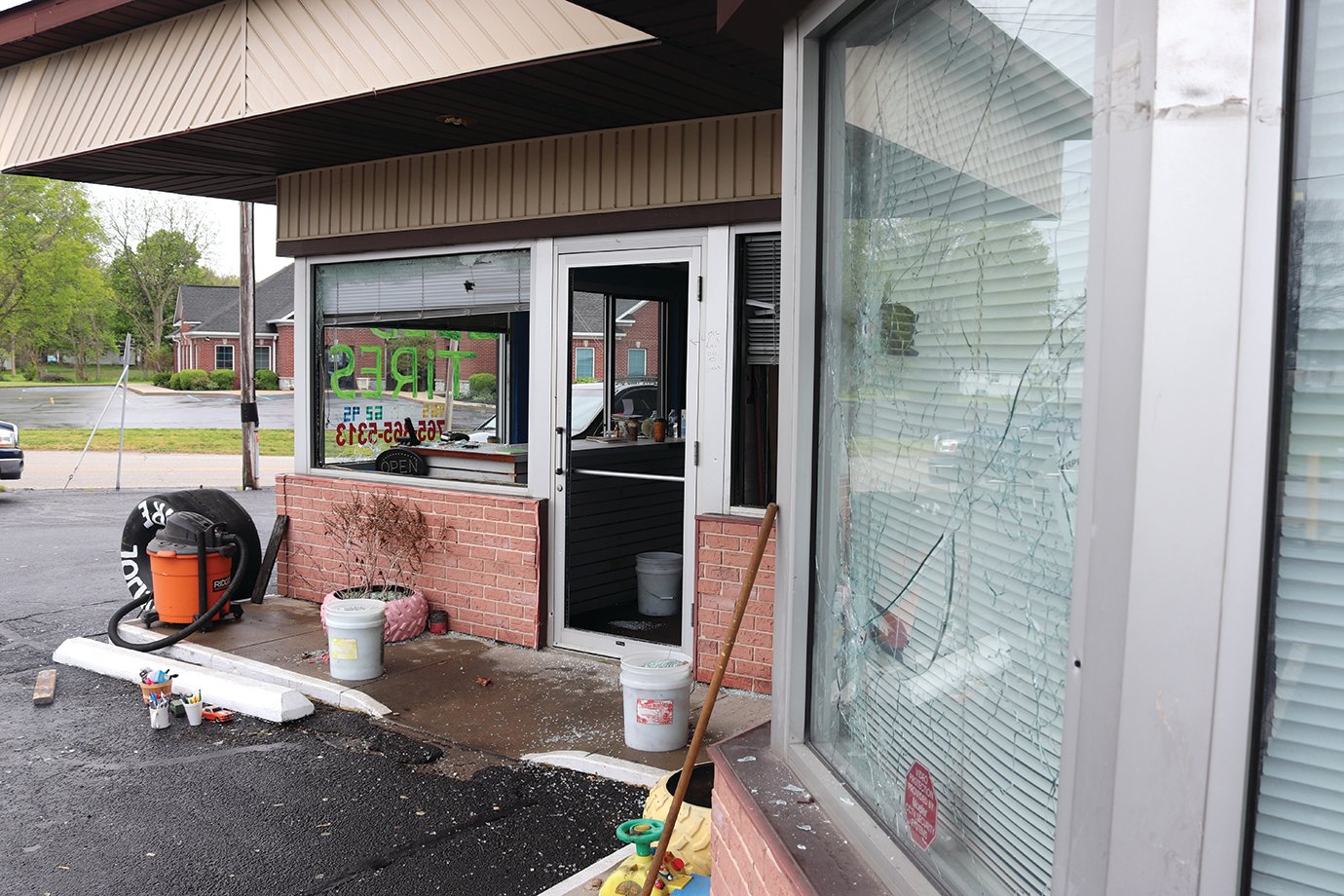 Shattered windows, a slew of bullet holes and signs of widespread damage were still apparent at 10 a.m. Friday as civilians were seen removing debris from the El Frijol Tire building and parking lot at 1000 S. Ladoga Road.