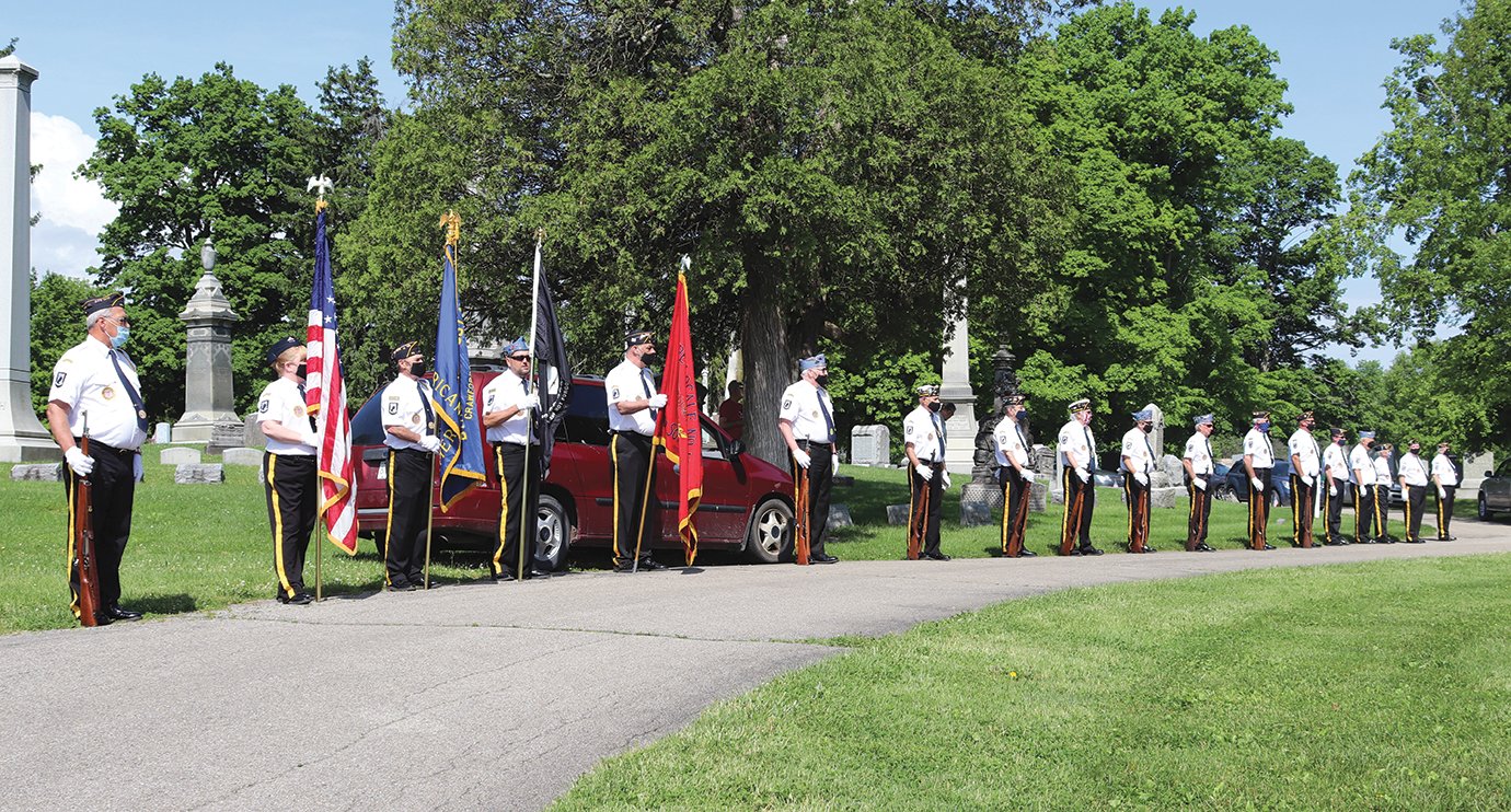 Military veterans and members of Byron Cox American Legion Post #72 perform their duties during Memorial Day services at Oak Hill Cemetery.