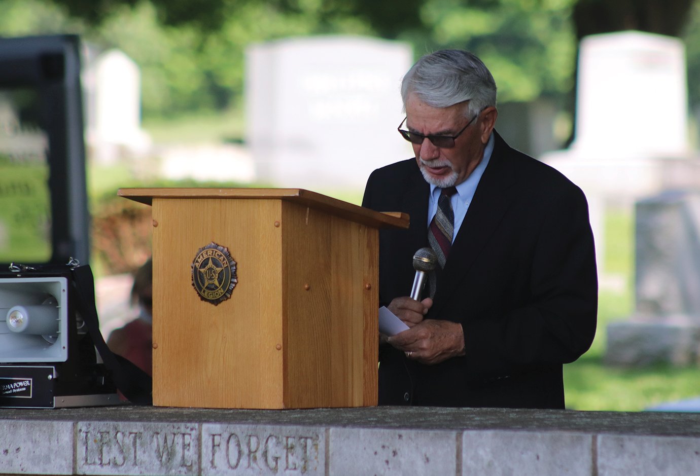 Reverend Mike Whitaker, former pastor of Whitesville Christian and New Hope Christian churches, delivers the opening prayer and later the benediction at Oak Hill Cemetery during services on Memorial Day.