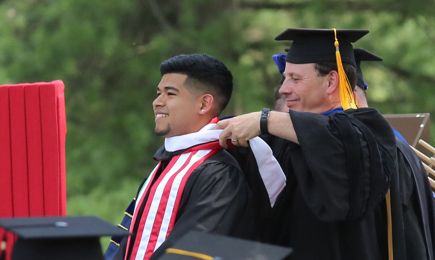 Dean of the College Scott E. Feller hoods a graduate during Wabash College's 2018 Commencement in Crawfordsville, Indiana. Feller was elected the 17th President of Wabash College on May 16 and begins his tenure on July 1, 2020.