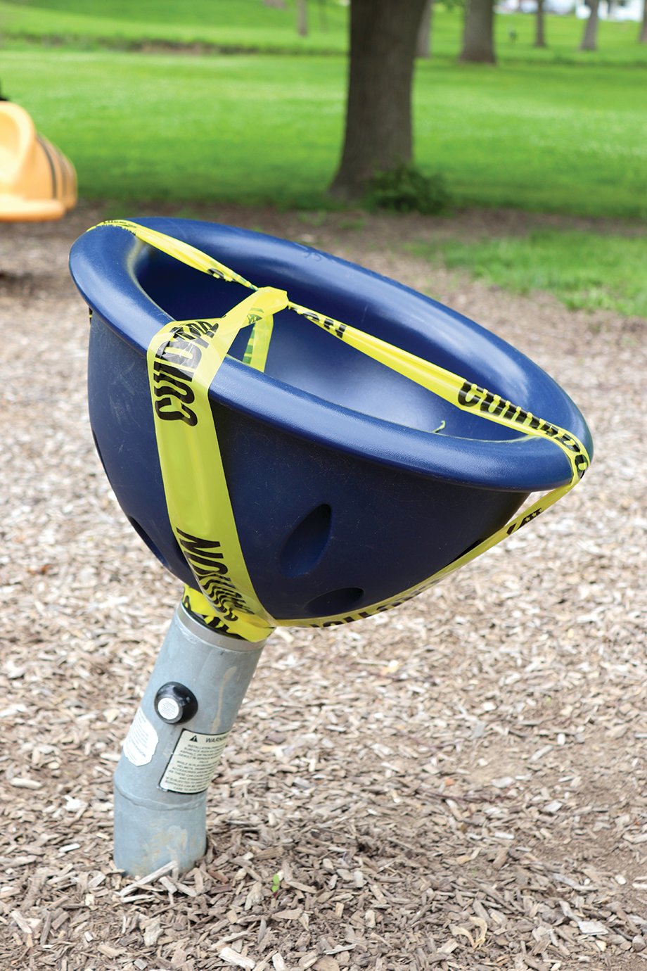 Slides, swing sets and other playground equipment stand dormant under caution tape Monday at Milligan Park. Though most park services have reopened, high-contact equipment such as playgrounds remained off limits until further notice.