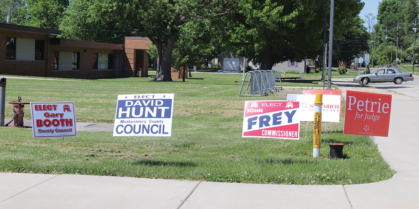 Signs supporting candidates Gary Booth, David Hunt, John Frey and Daniel Petrie greeted voters at the polling center at Hoover Elementary.