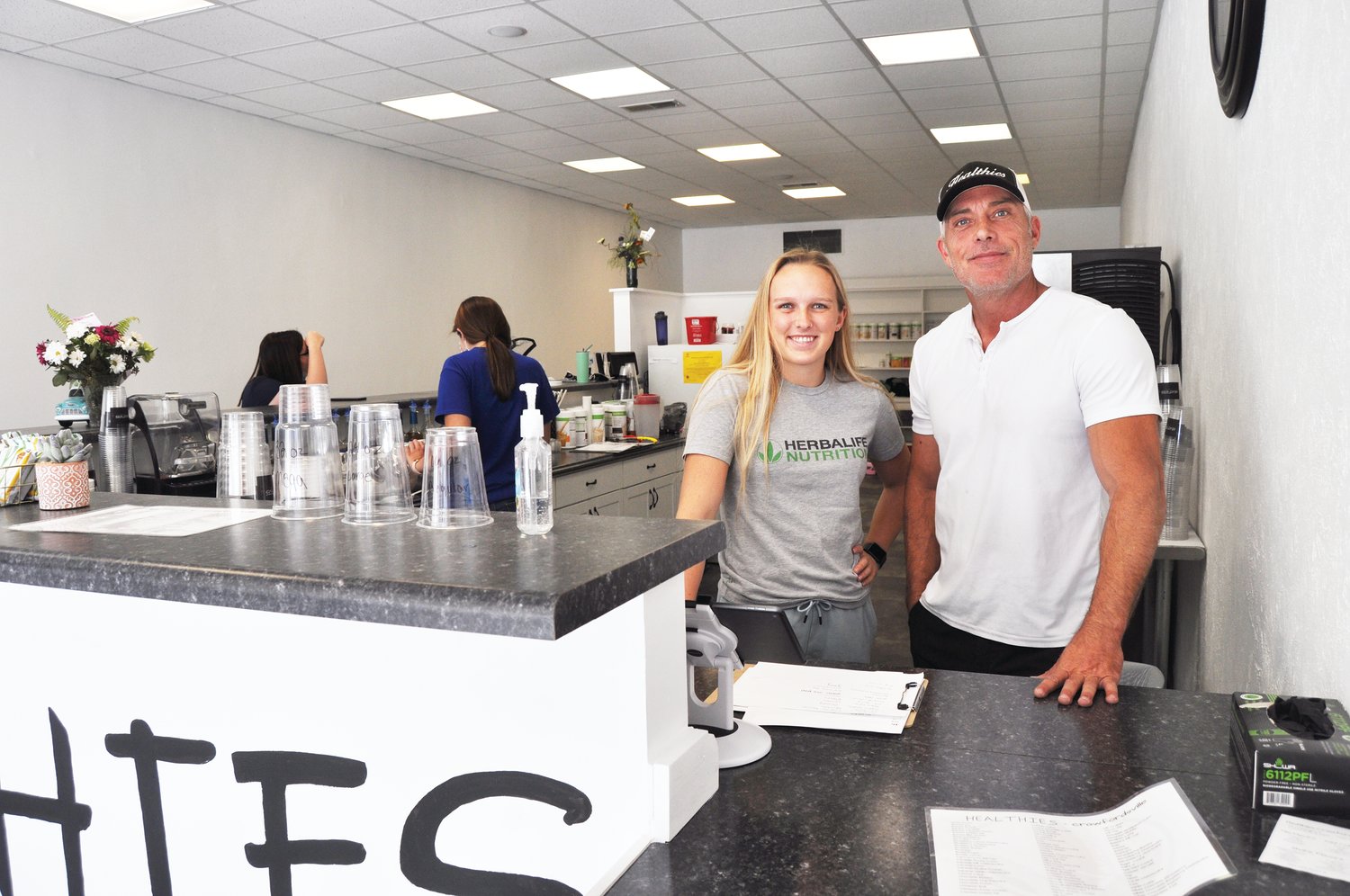 Jeremy Jones, right, and his daughter, Bailey, stand behind the counter Thursday at Healthies-Crawfordsville. The smoothie bar, which has locations in Greater Lafayette and northern Indiana, expanded to Montgomery County earlier this month.