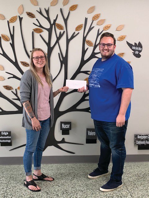 Maddy Edmiston of Integrated Wellness accepts a Drug Free Montgomery County mini-grant from Youth Service Bureau mini-grant coordinator Cameron Cole.