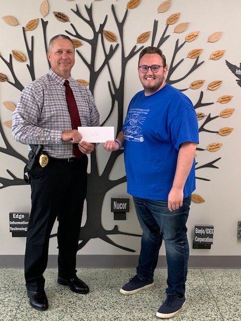 Crawfordsville Police Chief Mike Norman accepts a Drug Free Montgomery County mini-grant from Cameron Cole, mini-grant coordinator for the Youth Service Bureau.