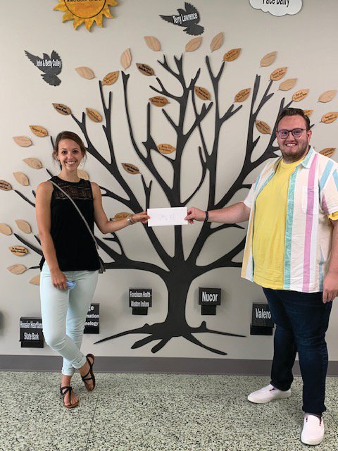 Samantha Cravens of the Montgomery County Health Department accepts a Drug Free Montgomery County mini-grant from Cameron Cole, mini-grant coordinator for the Youth Service Bureau.